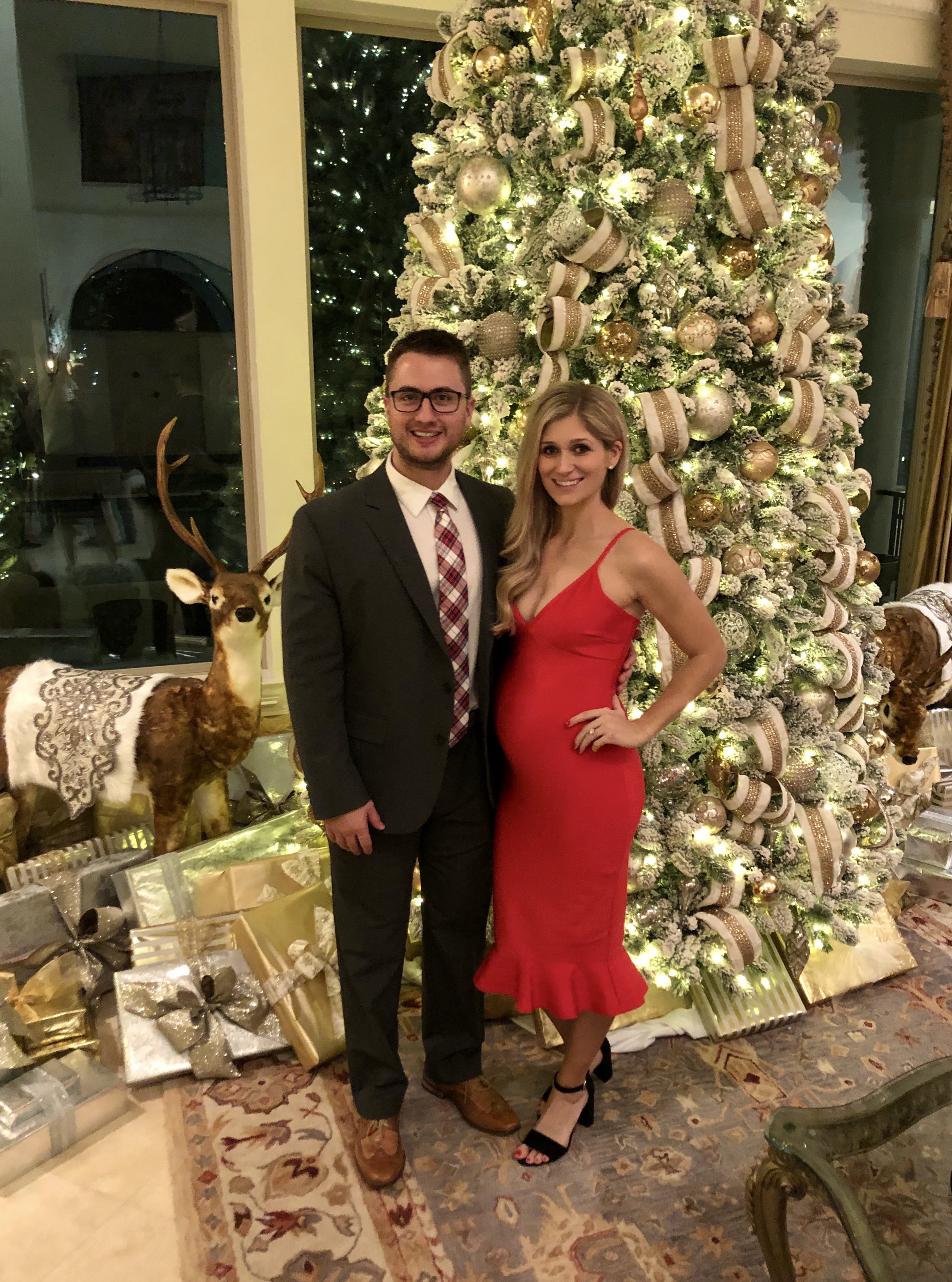 anthony and lauren gleisberg red dress in front of christmas tree
